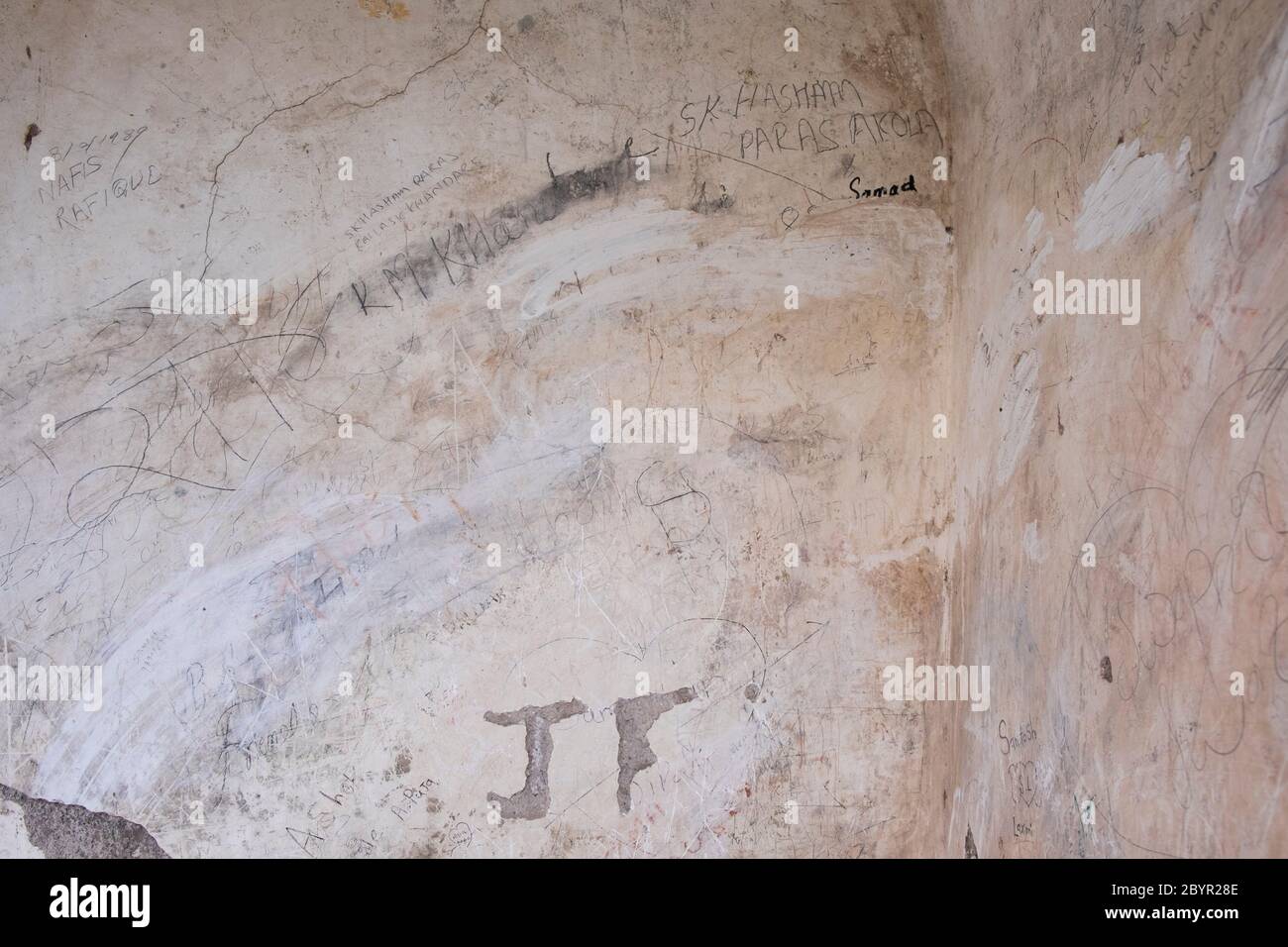 Vandalized by  tourists, a wall in the  Bibi-Ka-Maqbara. Aurangabad, Maharashtra, India. Stock Photo