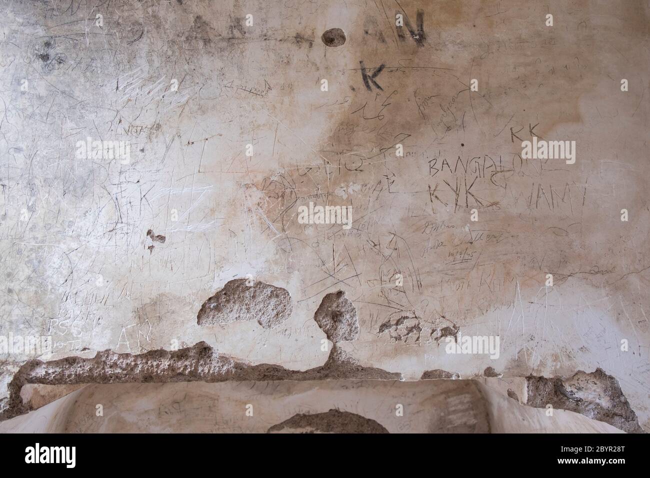 Vandalized by  tourists, a wall in the  Bibi-Ka-Maqbara. Aurangabad, Maharashtra, India. Stock Photo