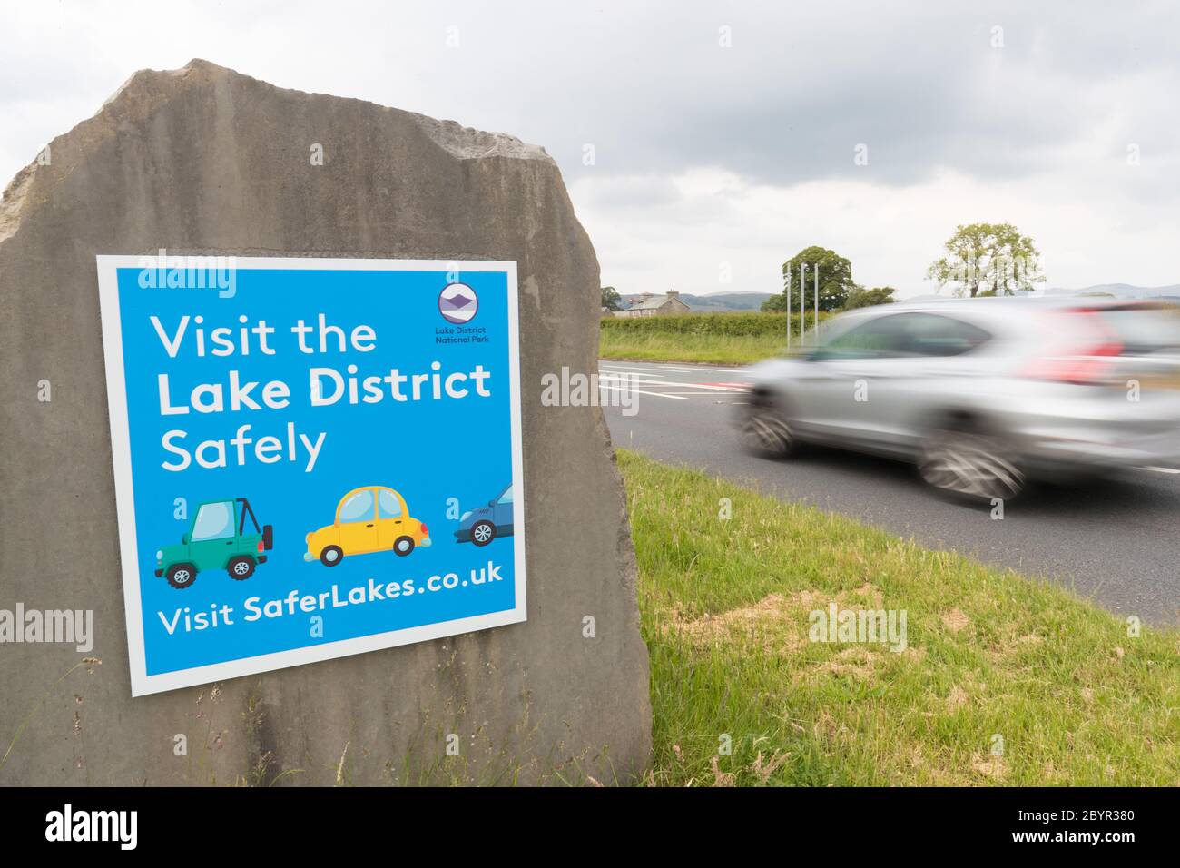 Visit the Lake District Safely sign at the entrance to the National Park  just out side Kendal .Sign put up when Government  aloud car journeys in UK Stock Photo