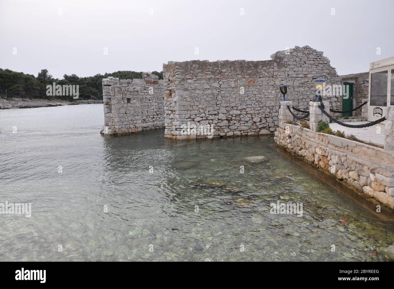 Stone wall in the sea at port. Big stone wall in the sea. Stock Photo