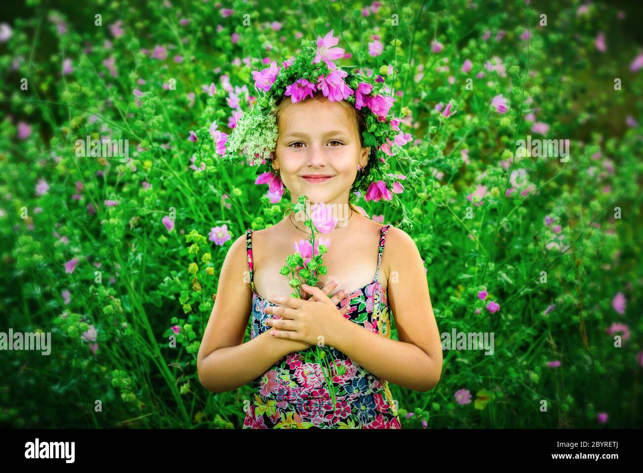Portrait of a little girl in wreath of flowers Stock Photo - Alamy