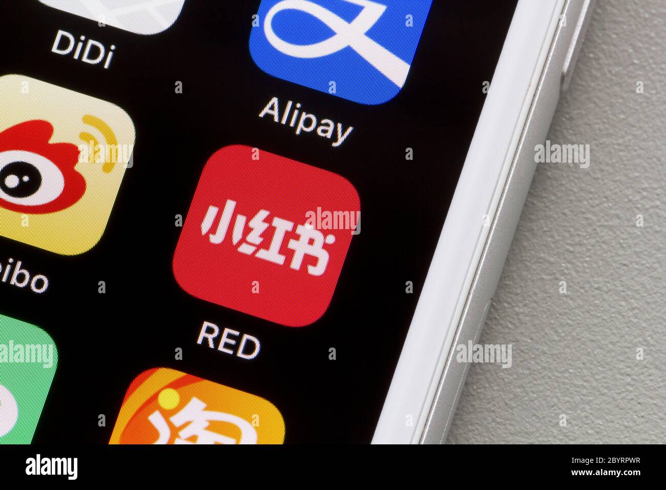 Xiaohongshu app icon is seen on an iPhone. Also known as RED, it is a Chinese social media platform that blends e-commerce and user-generated content. Stock Photo