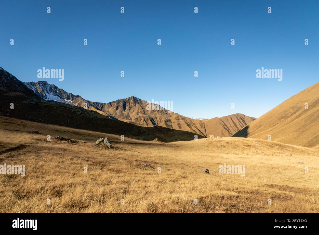 dramatic mountain hiking landscape in Juta trekking area landscape in autumn - popular trekking in the Caucasus mountains, Kazbegi region, Georgia. Stock Photo