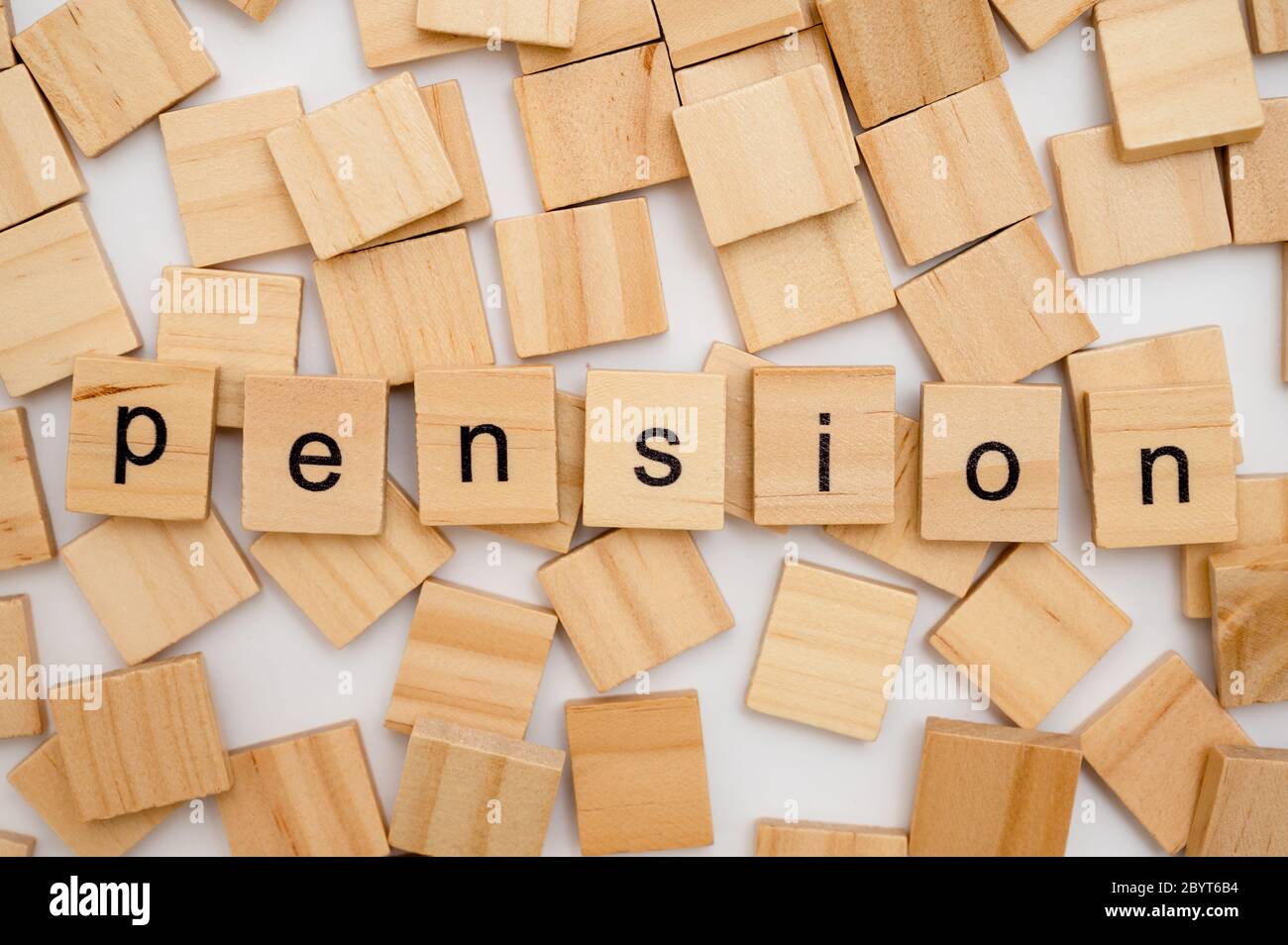 Wood letter tiles spelling word PENSION lying on a pile of tiles Stock Photo
