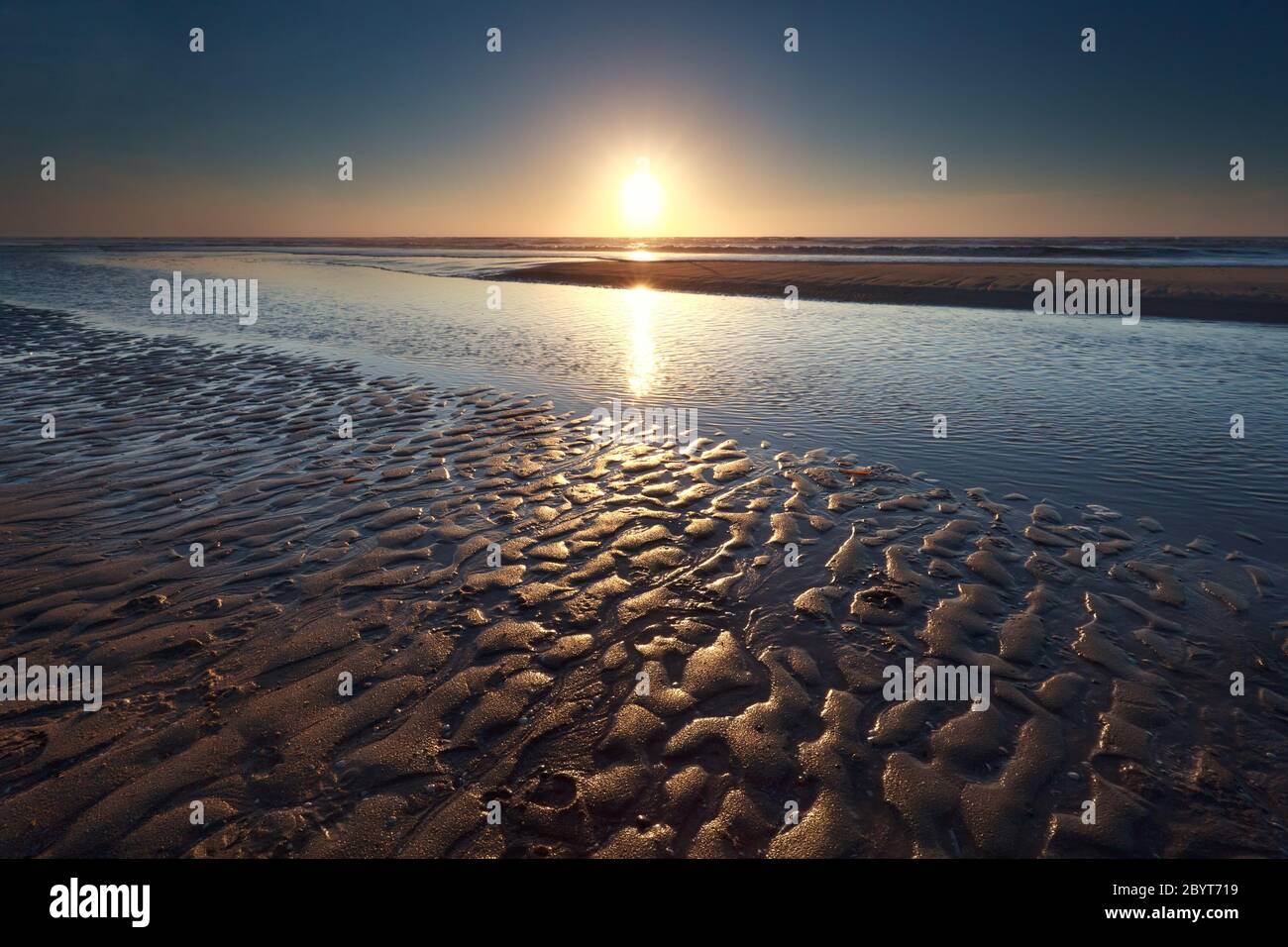 sunset over sand beach on North sea Stock Photo - Alamy