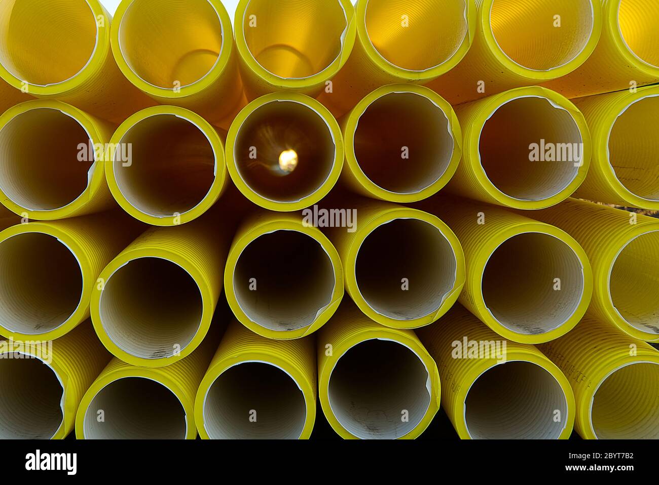 yellow plastic pipes for laying electricity cables underground. texture