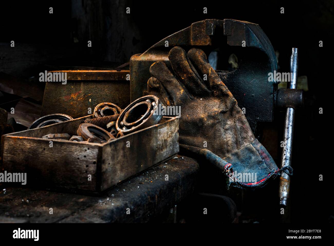 A central a glove and some rusty bearing kits in a car