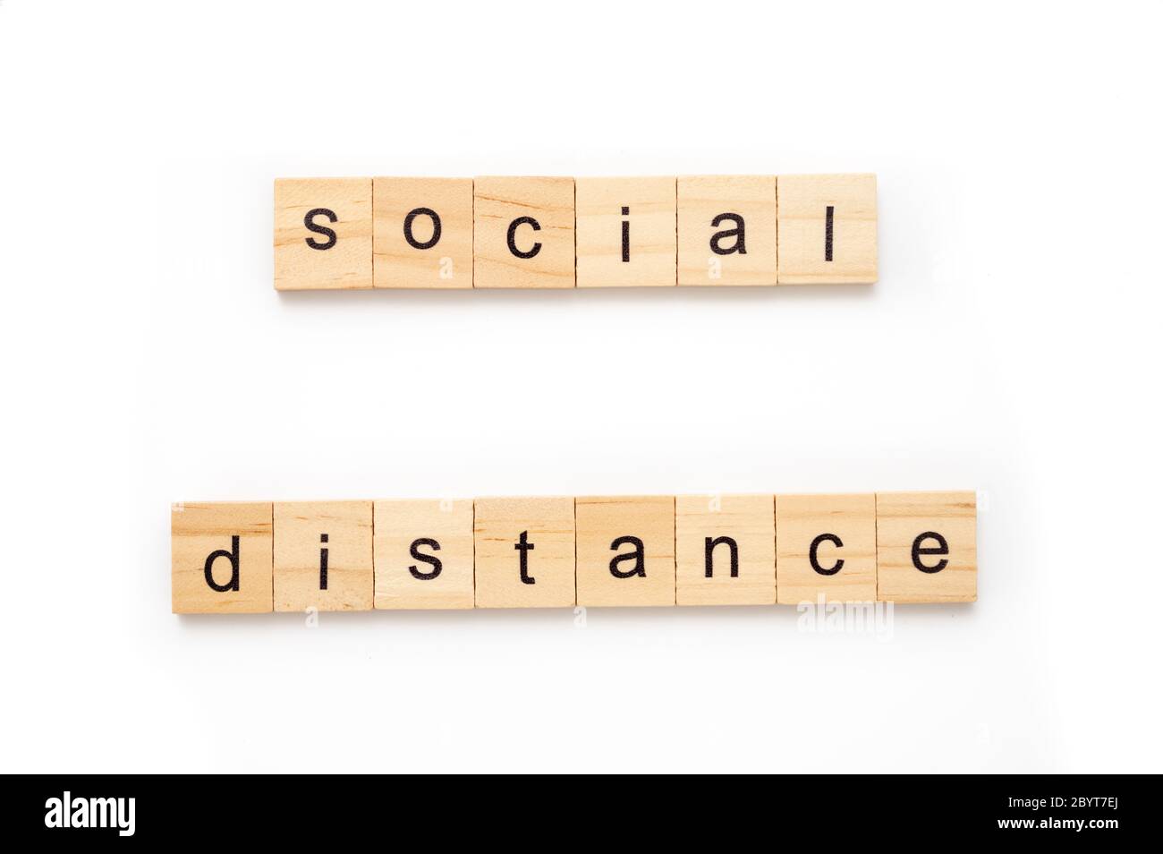 Generic wood scrabble tiles spelling words Social Distance Stock Photo