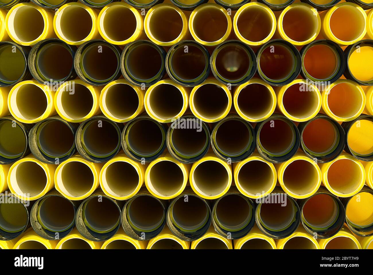 yellow plastic pipes for laying electricity cables underground. texture
