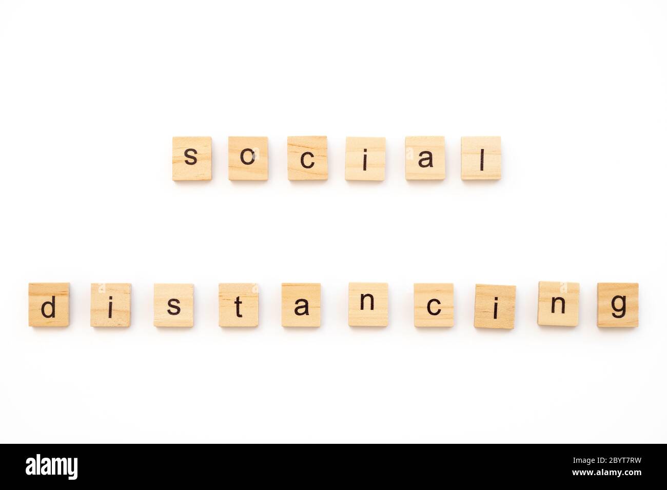Generic wood scrabble tiles spelling words Social Distancing Stock Photo