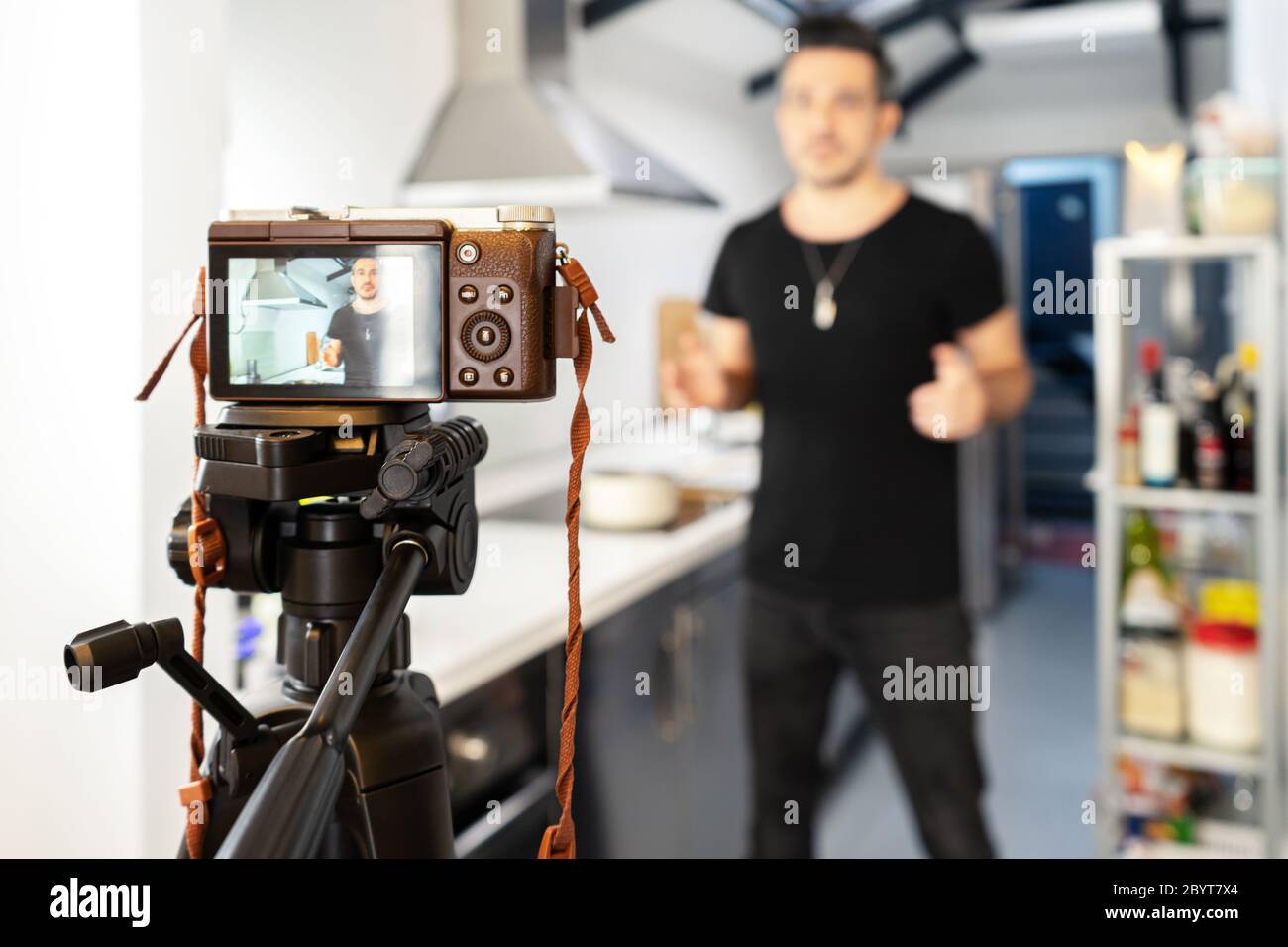 Food blogger blogger is recording tutorial online in front of camera. Welness coach. vlog video live streaming at home Stock Photo