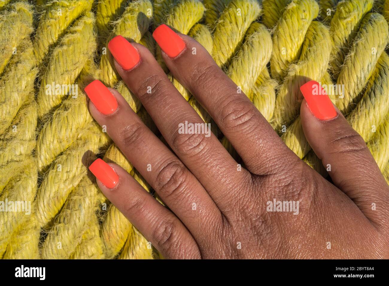womans hand on mooring rope background Stock Photo