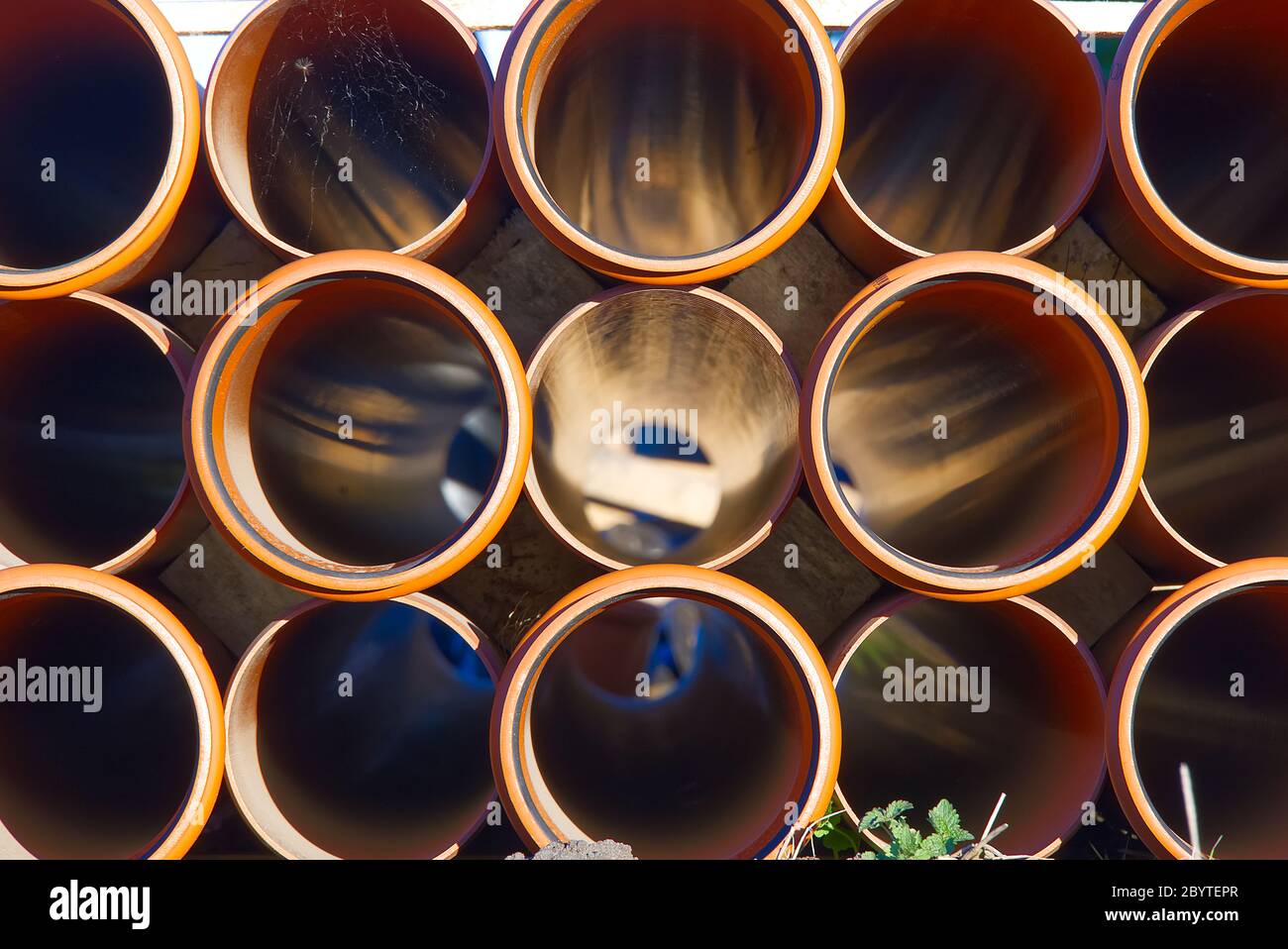 orange sewer pipes at a construction site. Underground orange plastic