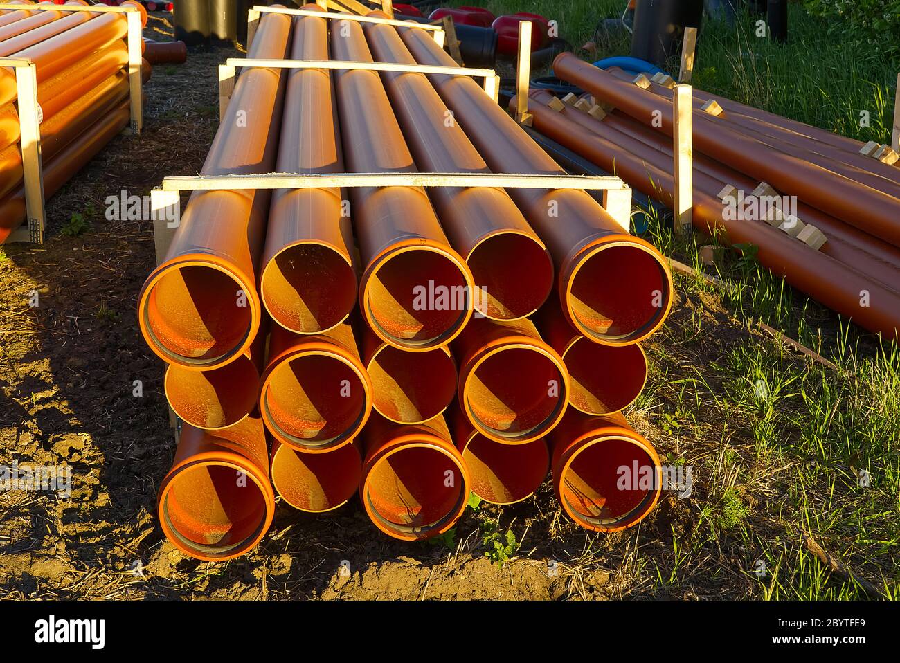 orange sewer pipes at a construction site. Underground orange plastic