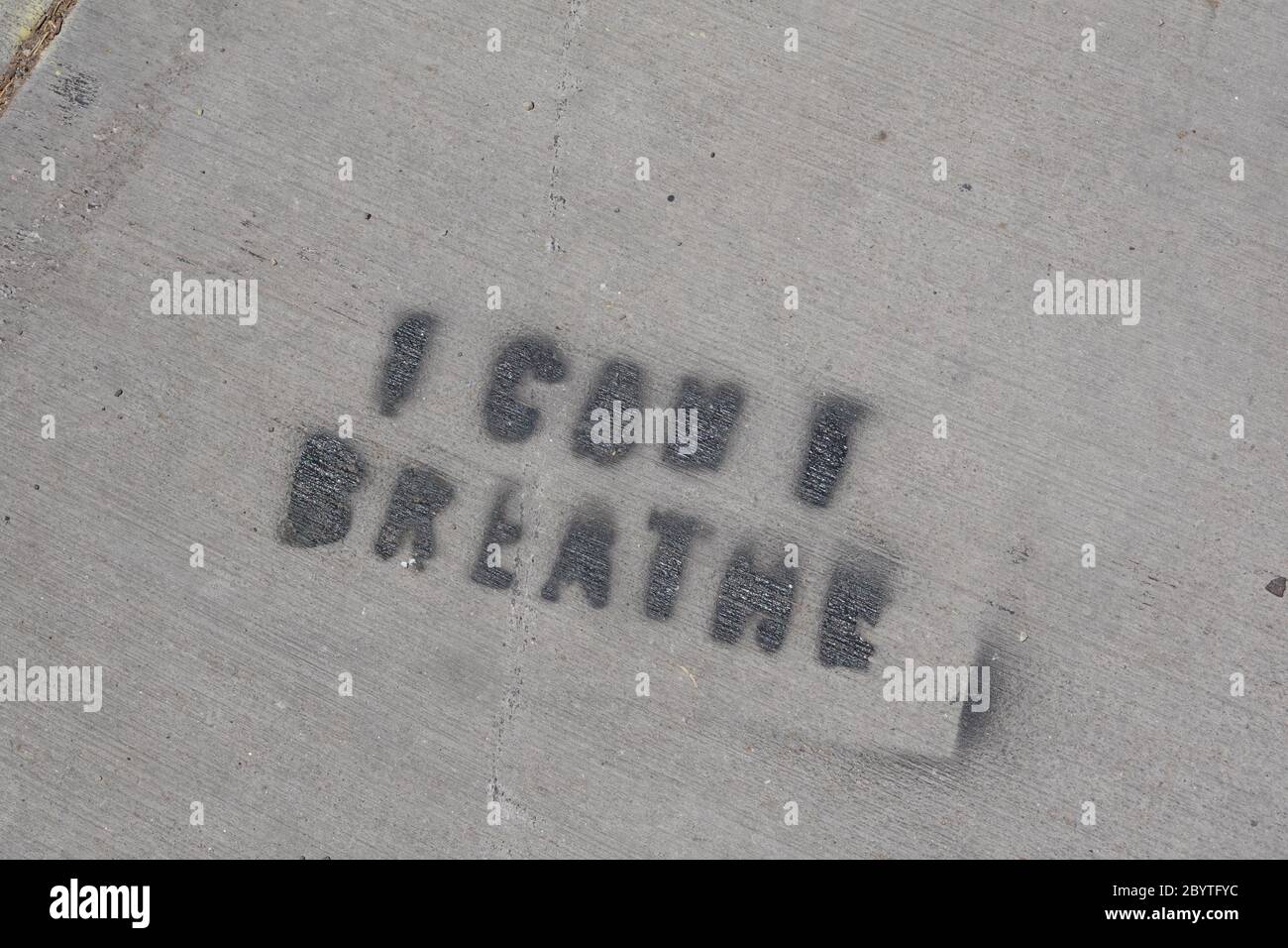 I can’t breathe is spray painted on a sidewalk. Stock Photo