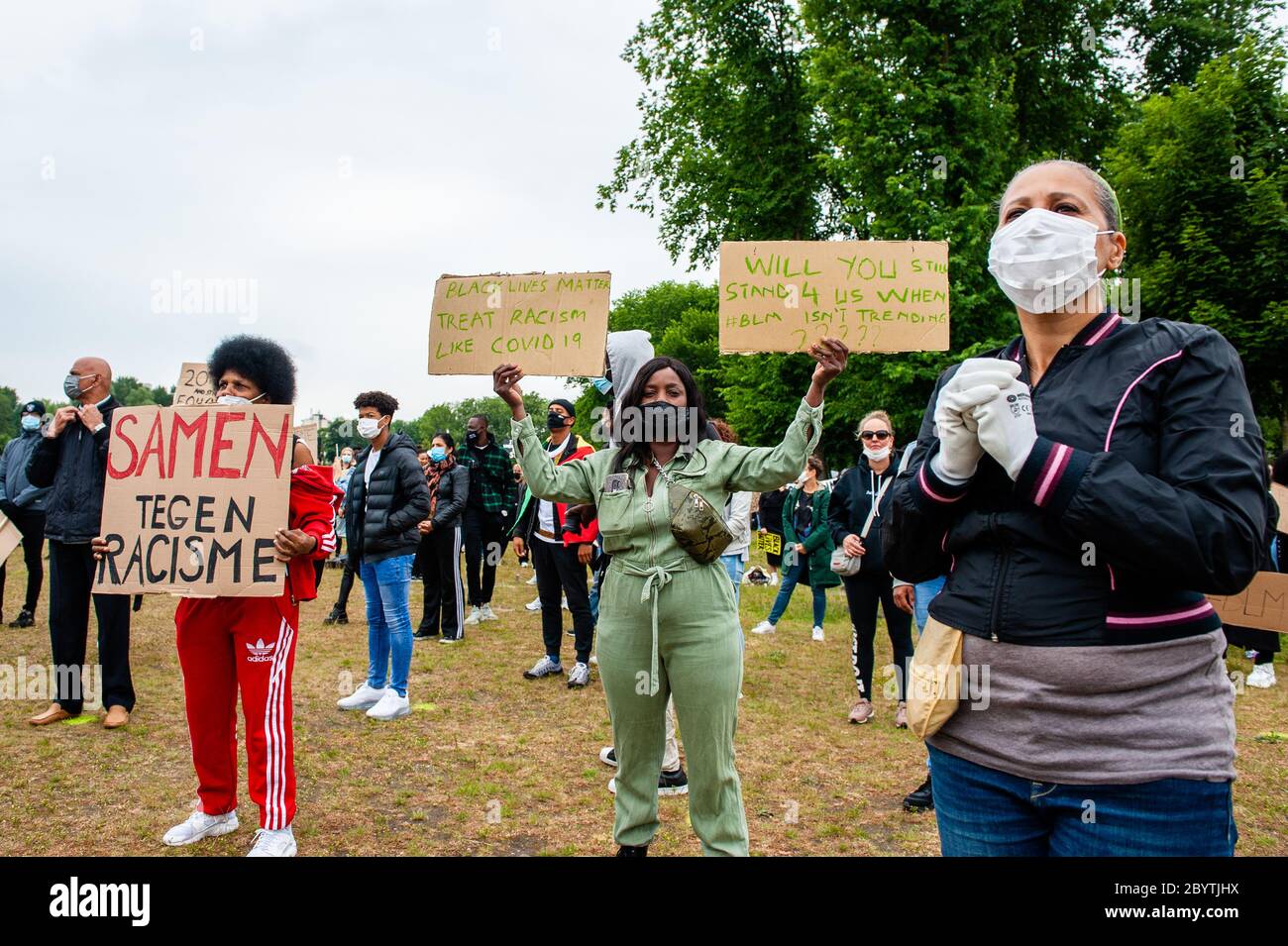 Protesters holding placards during the demonstration.Thousands of people gathered at the Nelson Mandela Park to protest against police brutality and racism which is an initiative of residents of the Bijlmer district, the largest population of Afro-Dutch people in Amsterdam. The black community has been a victim of oppression for decades since the 1990s. Stock Photo