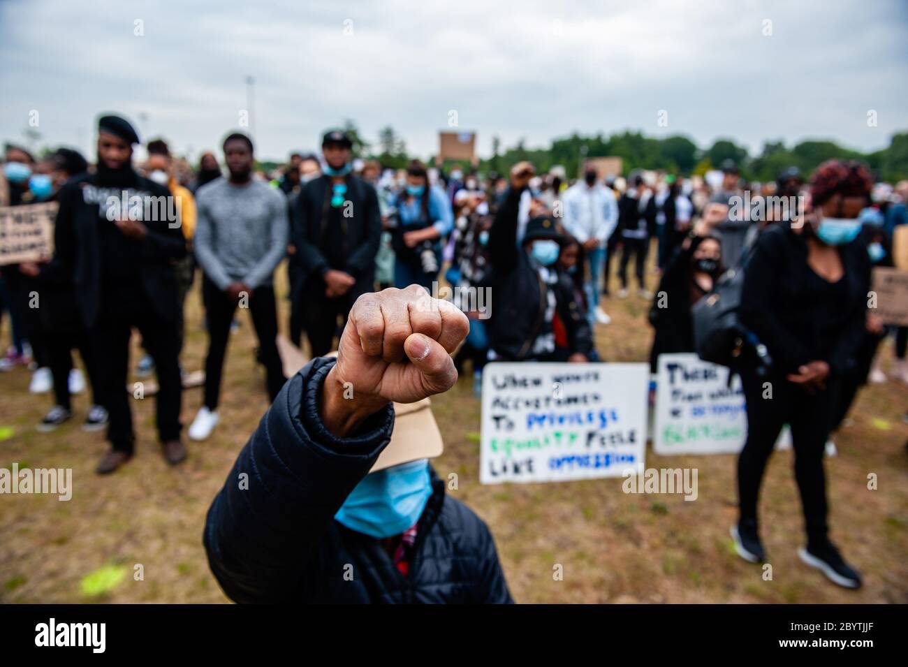 A man is seen taking a knee during the demonstration.Thousands of people gathered at the Nelson Mandela Park to protest against police brutality and racism which is an initiative of residents of the Bijlmer district, the largest population of Afro-Dutch people in Amsterdam. The black community has been a victim of oppression for decades since the 1990s. Stock Photo