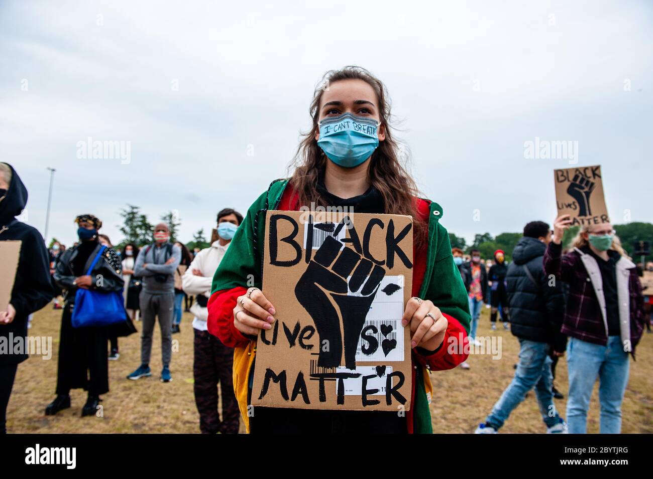 A protester holding a BLM placard during the demonstration.Thousands of people gathered at the Nelson Mandela Park to protest against police brutality and racism which is an initiative of residents of the Bijlmer district, the largest population of Afro-Dutch people in Amsterdam. The black community has been a victim of oppression for decades since the 1990s. Stock Photo