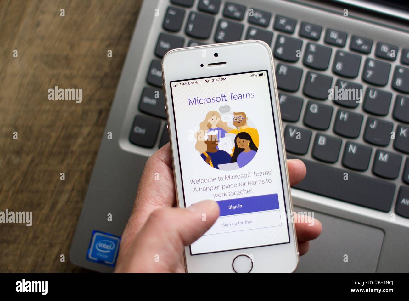 A user opens the Microsoft Teams mobile app. Teams is a unified team communication and collaboration platform with workplace chat, video meetings, etc. Stock Photo