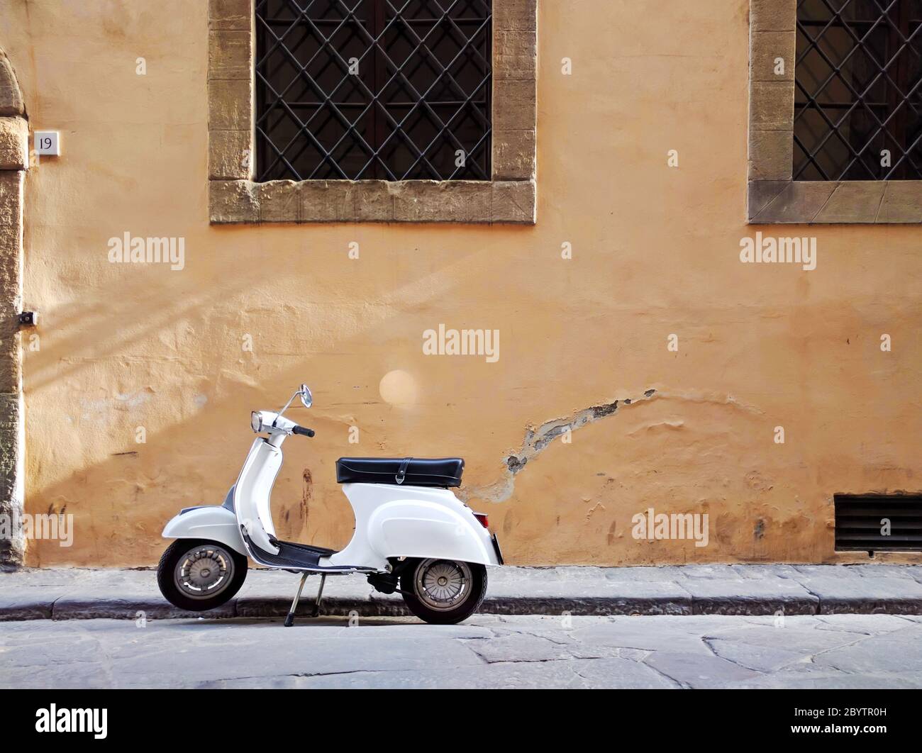 Rome - 26 May 2016 - View of Traditional White Moped on Rusitc Italian Street in Rome, Italy Stock Photo