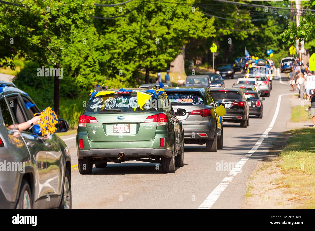 Cars in a rolling rally to celebrate graduating highschool seniors ...
