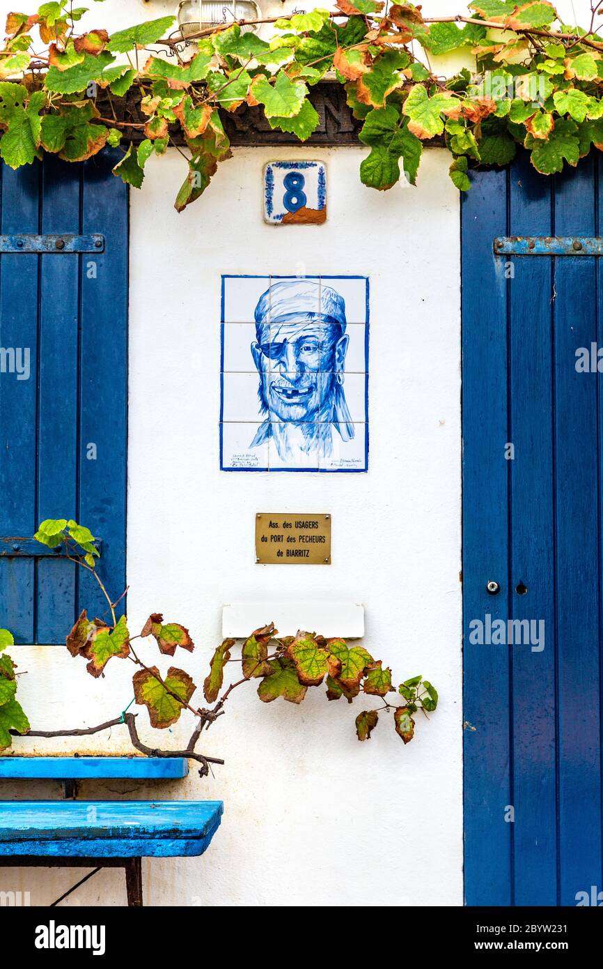 Painted tiles with a pirate face in Le Port des Pêcheurs fishing port, Biarritz, France Stock Photo