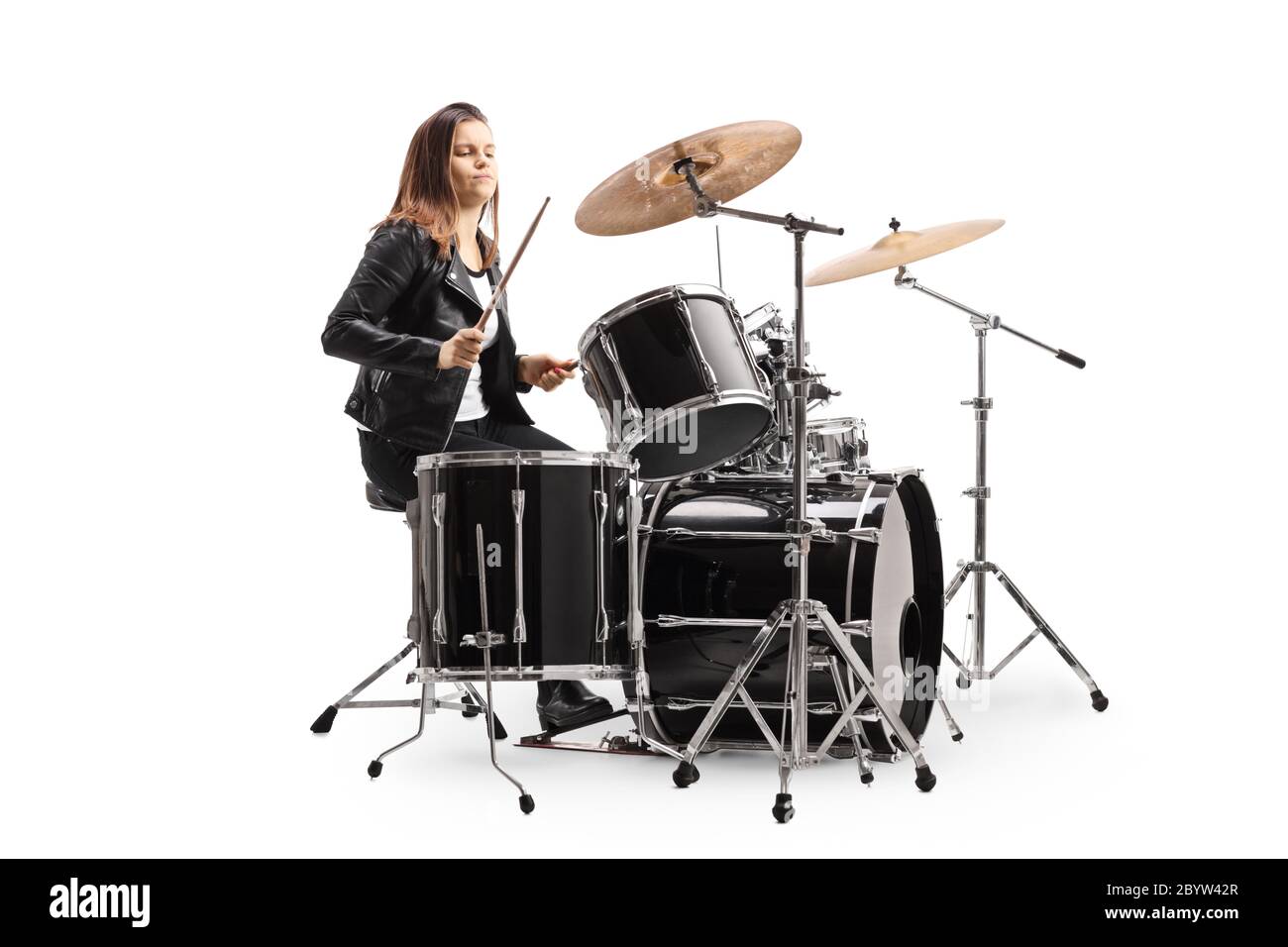 Young female musician playing a drum kit isolated on white background Stock Photo