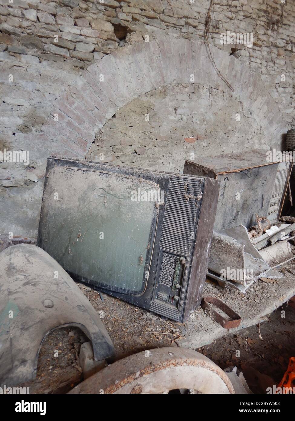 An old television set abandoned and covered in dust Stock Photo