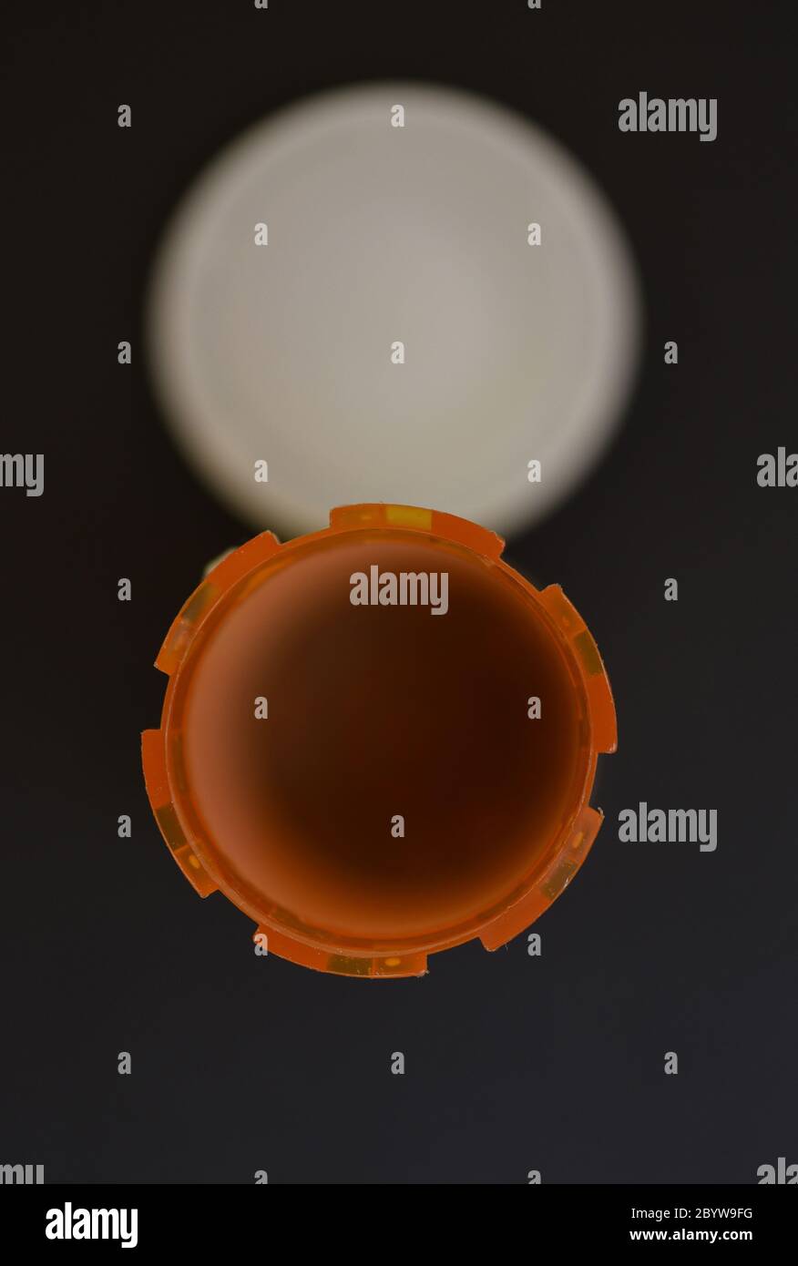 The interior of an empty prescription medicine container with the lid