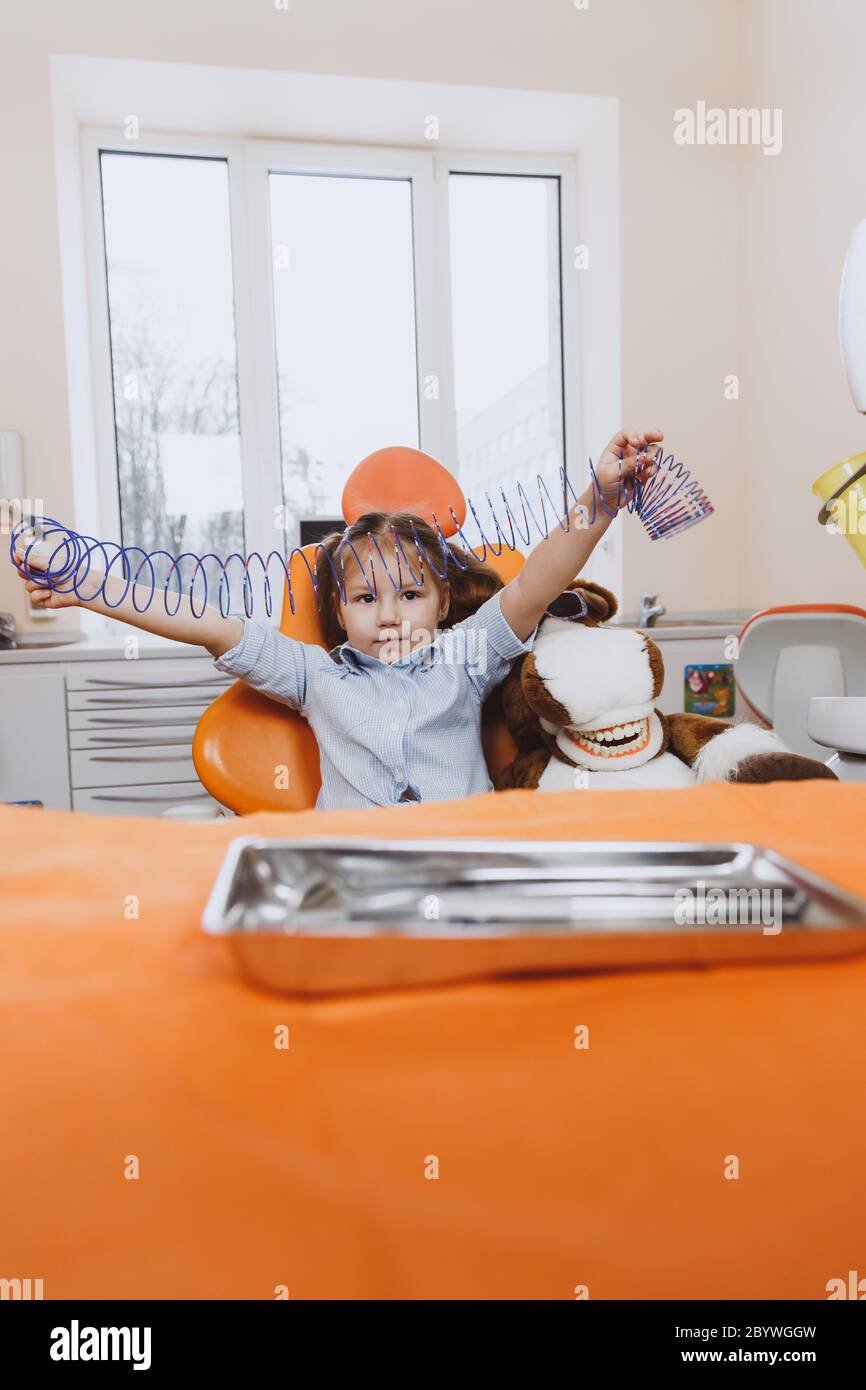 Little girl playing on dentist chair Stock Photo Alamy