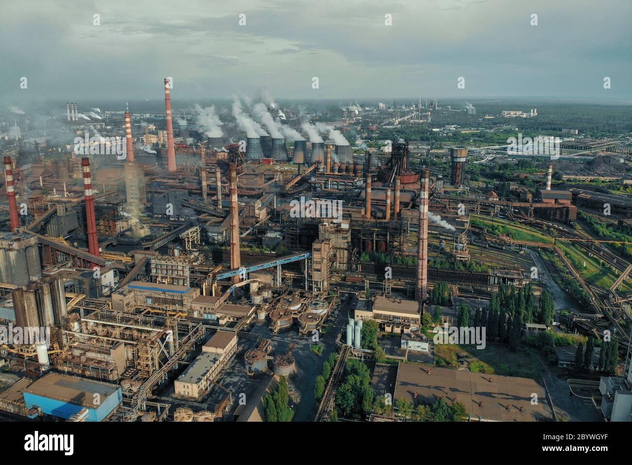 Aerial view of huge Metallurgical Plant, smokestacks and chimneys with smoke. Environmental pollution from petrochemical production industrial factory. Stock Photo