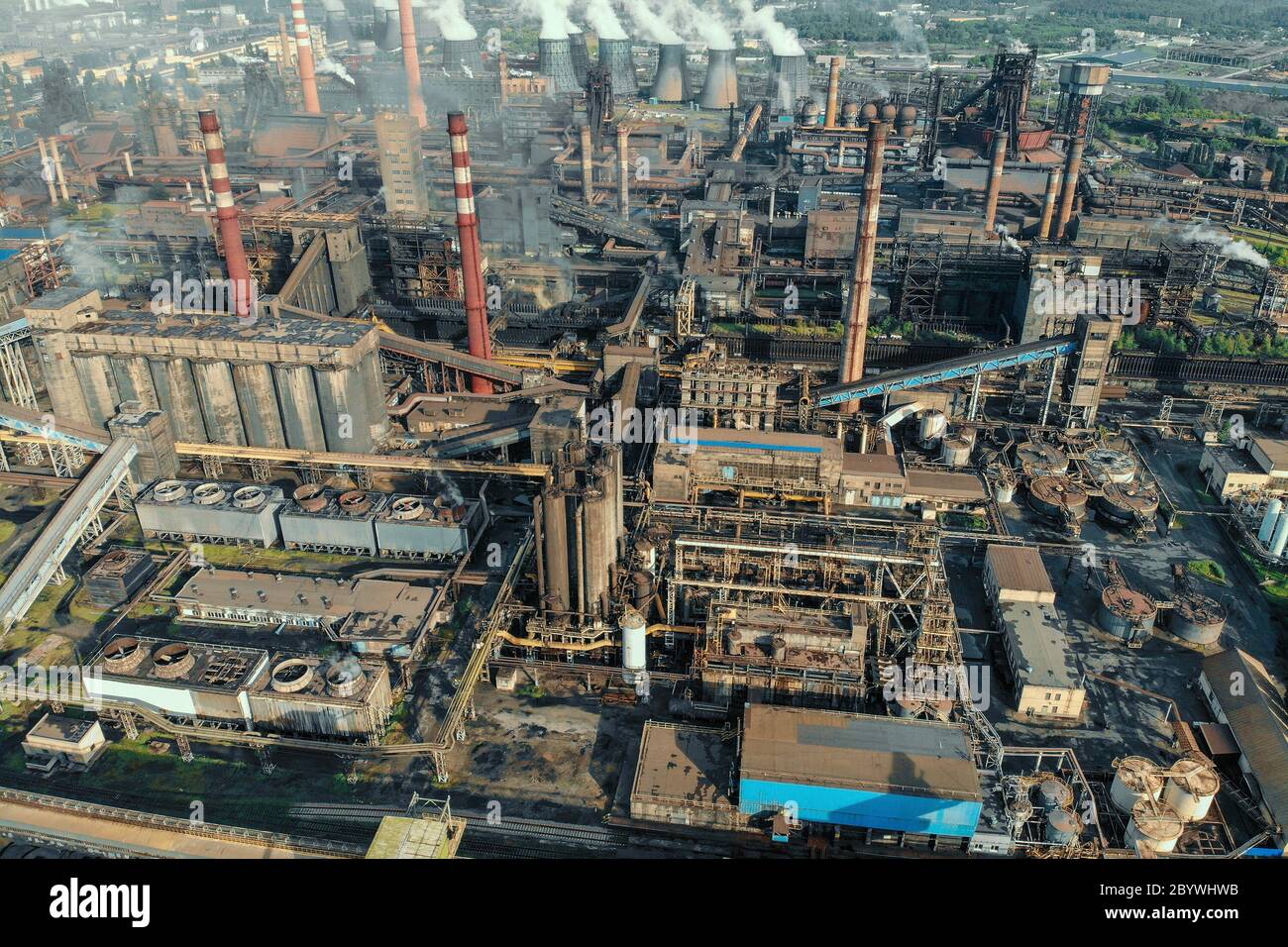 Aerial view of huge Metallurgical Plant, smokestacks and chimneys with smoke. Environmental pollution from petrochemical production industrial factory. Stock Photo