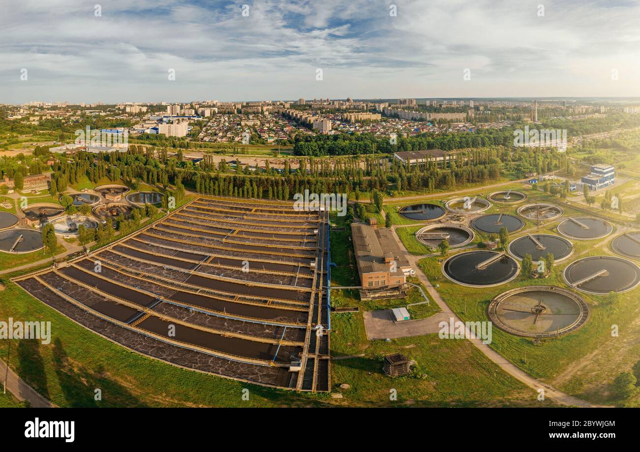 Modern urban wastewater treatment plant with sedimentation tanks and pools for aeration and cleaning of sewer water, aerial view. Stock Photo