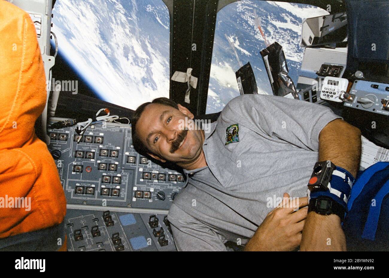 7 - 19 August 1997) --- Astronaut Curtis L. Brown, Jr., mission commander,  floats on the flight deck of Space Shuttle Discovery. The horizon of Earth  is visible through the aft flight