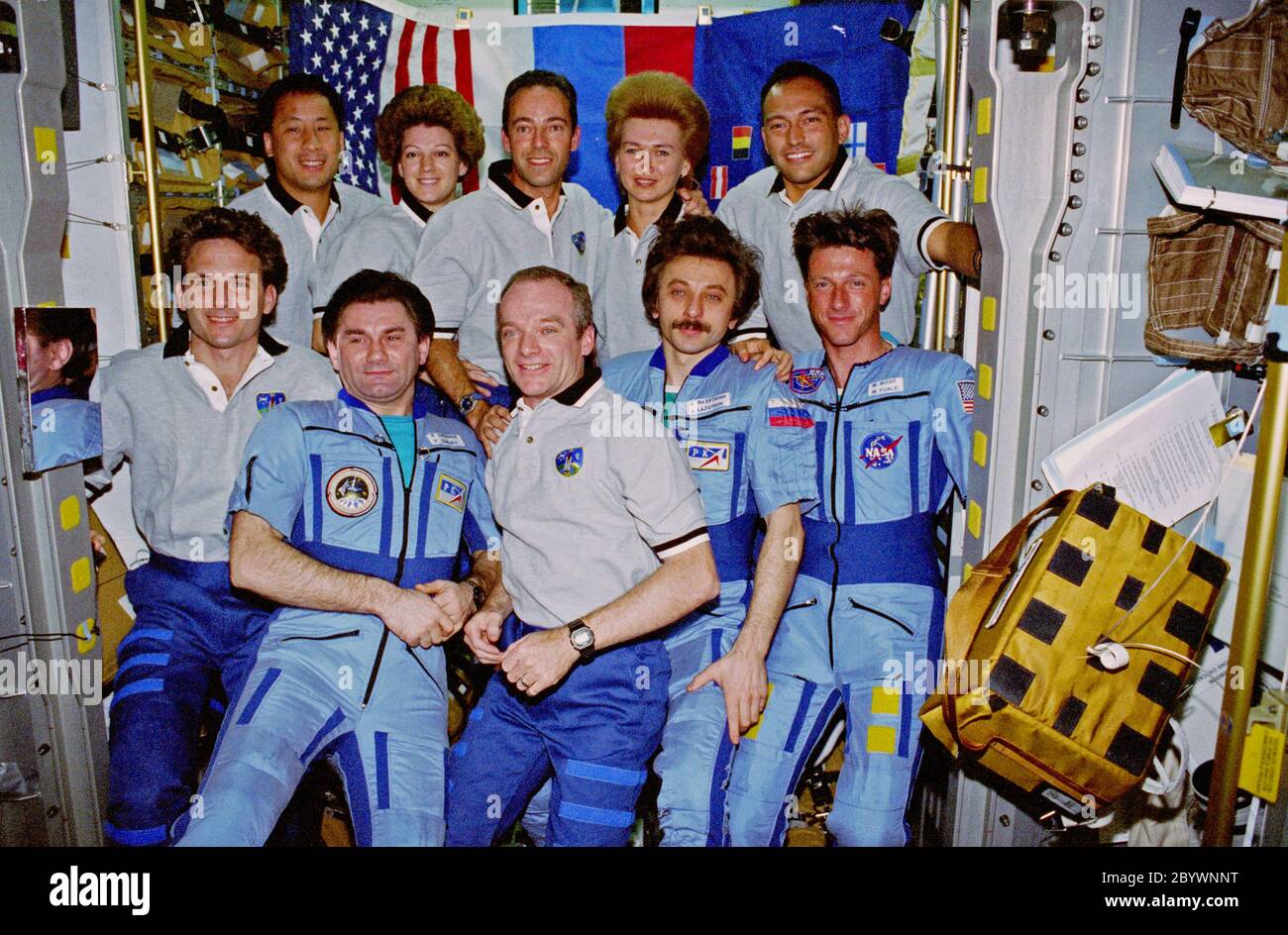 Crewmembers from Mir-23 and STS-84 assemble for a group portrait ...