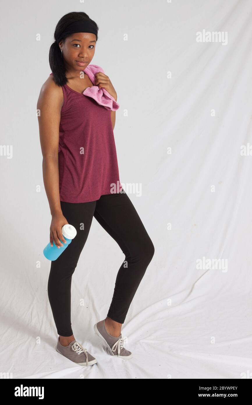Lovely Black woman with exercise towel and water bottle Stock Photo - Alamy