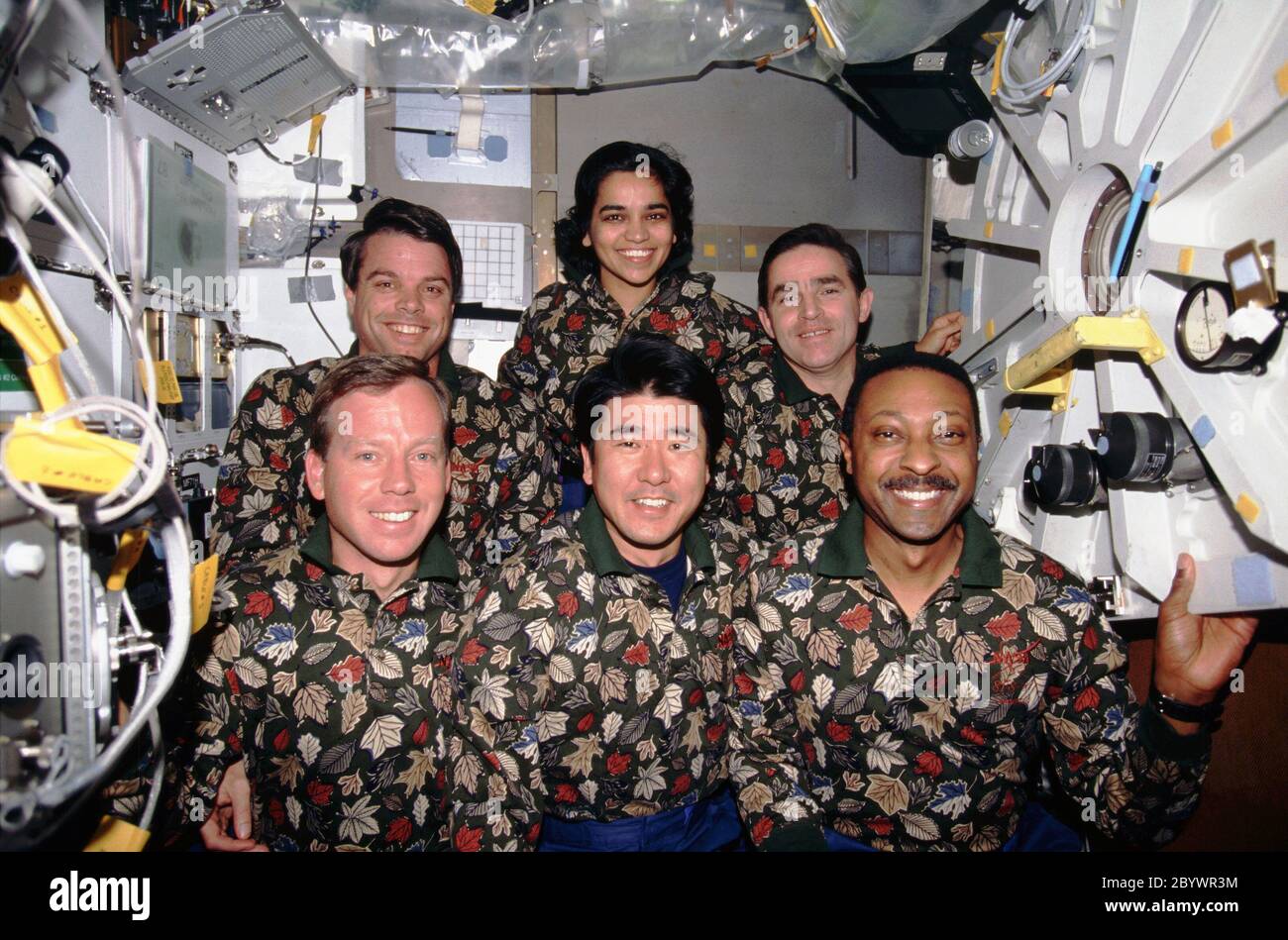 (19 November – 5 December 1997) --- One of the crew members' traditional in-flight crew portraits has them posed in other-than traditional attire on the Space Shuttle Columbia's mid-deck.  On the front row, from the left, are astronauts Steven W. Lindsey, pilot; Takao Doi, an international mission specialist representing Japan's National Space Development Agency (NASDA); and Winston E. Scott, mission specialist.  In the back are astronauts Kevin R. Kregel, mission commander; and Kalpana Chawla, mission specialist, along with Ukrainian payload specialist Leonid K. Kadenyuk. Stock Photo