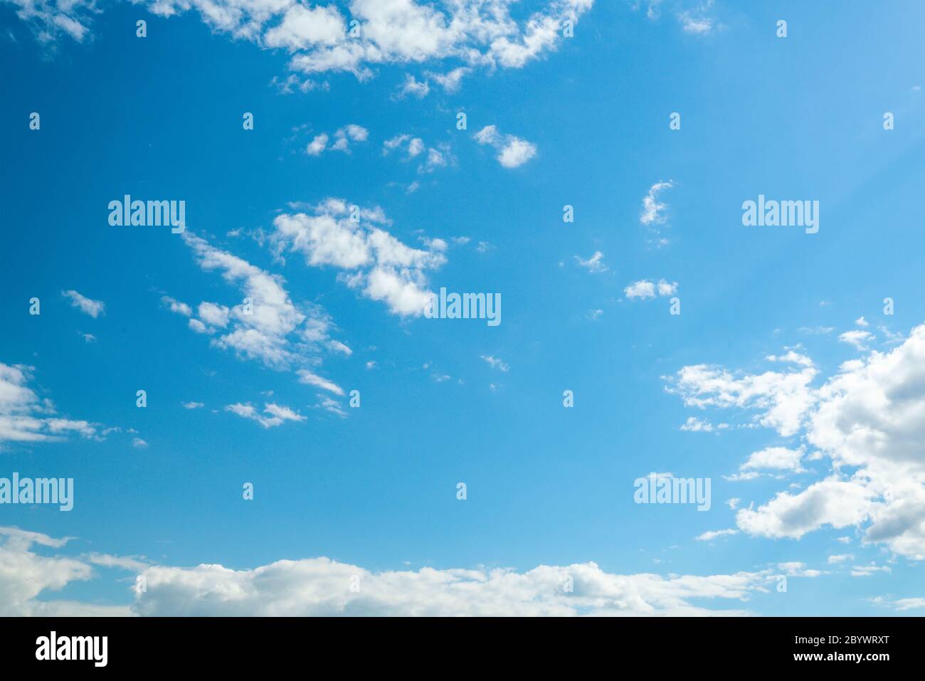 Beautiful clouds on the clear blue sky and sun Stock Photo - Alamy