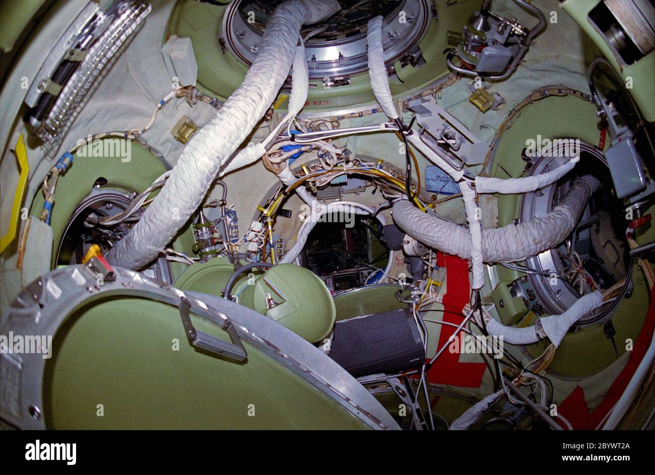 (15-24 May 1997) --- As seen from the docked Soyuz hatchway, this 35mm view shows the interior of a Russian Mir Space Station node connected to Kristall (bottom), Priroda (top), Mir Core Module (center), Kvant-2 (left) and Spektr (right). The Mir-23 and STS-84 crew members spent several days sharing joint activities in Earth-orbit as part of an ongoing cooperative program between the Russian Space Agency (RSA) and National Aeronautics and Space Administration (NASA). Stock Photo