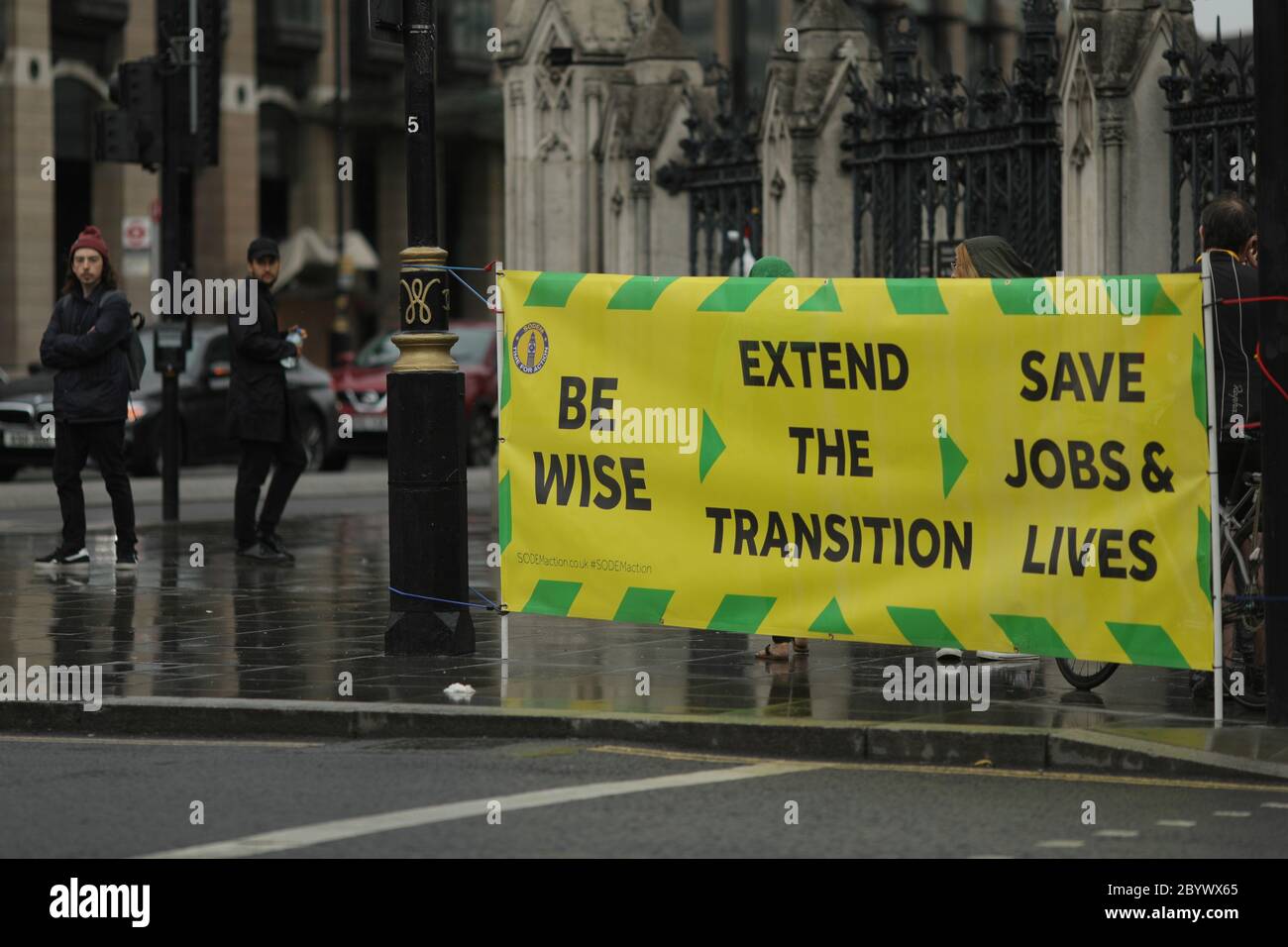 London, Britain. 10th June, 2020. People walk past a banner demanding extension of Brexit transition period outside the Houses of Parliament in London, Britain, on June 10, 2020. Britain will not extend its transitional links to the European Union (EU) beyond Dec. 31, a government minister said Tuesday following the stalled talks between London and Brussels last week. Credit: Tim Ireland/Xinhua/Alamy Live News Stock Photo