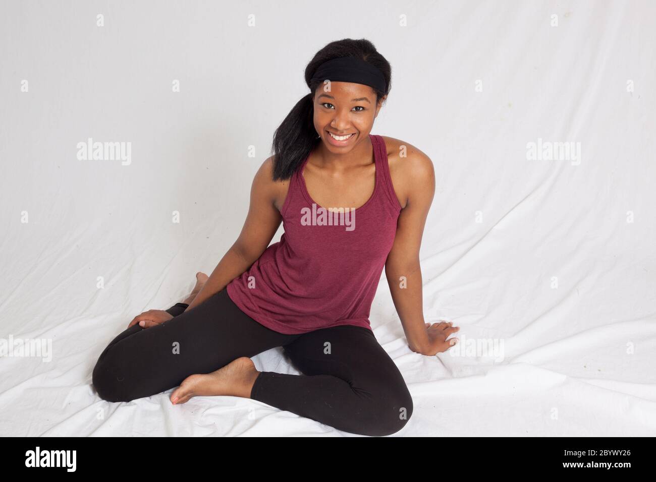 Beautiful Black woman sitting on the floor Stock Photo - Alamy