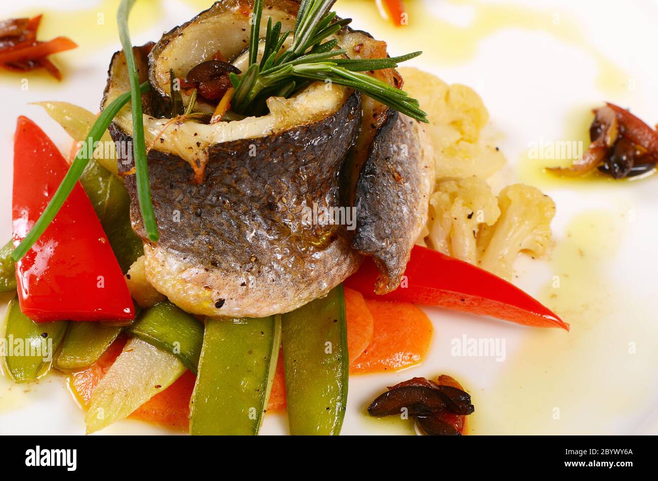 Sea bass fillet with spring vegetables Stock Photo Alamy