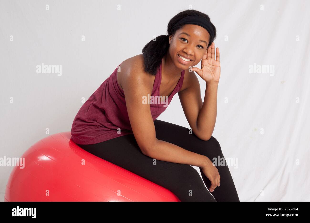 Lovely black woman sitting on an exercise ball Stock Photo Alamy