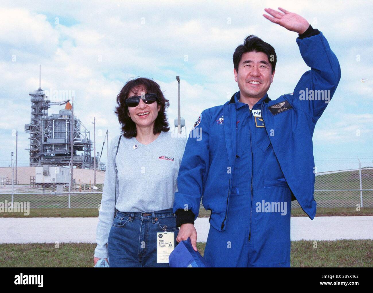 STS-87 Mission Specialist Takao Doi, Ph.D., of the National Space Development Agency of Japan poses with his wife, Hitomi Doi, in front of Kennedy Space Center's Launch Pad 39B during final prelaunch activities leading up to the scheduled Nov. 19 liftoff. The other STS-87 crew members are Commander Kevin Kregel; Pilot Steven Lindsey; Mission Specialists Kalpana Chawla, Ph.D., and Winston Scott; and Payload Specialist Leonid Kadenyuk of the National Space Agency of Ukraine. STS-87 will be the fourth flight of the United States Microgravity Payload and the Spartan-201 deployable satellite Stock Photo