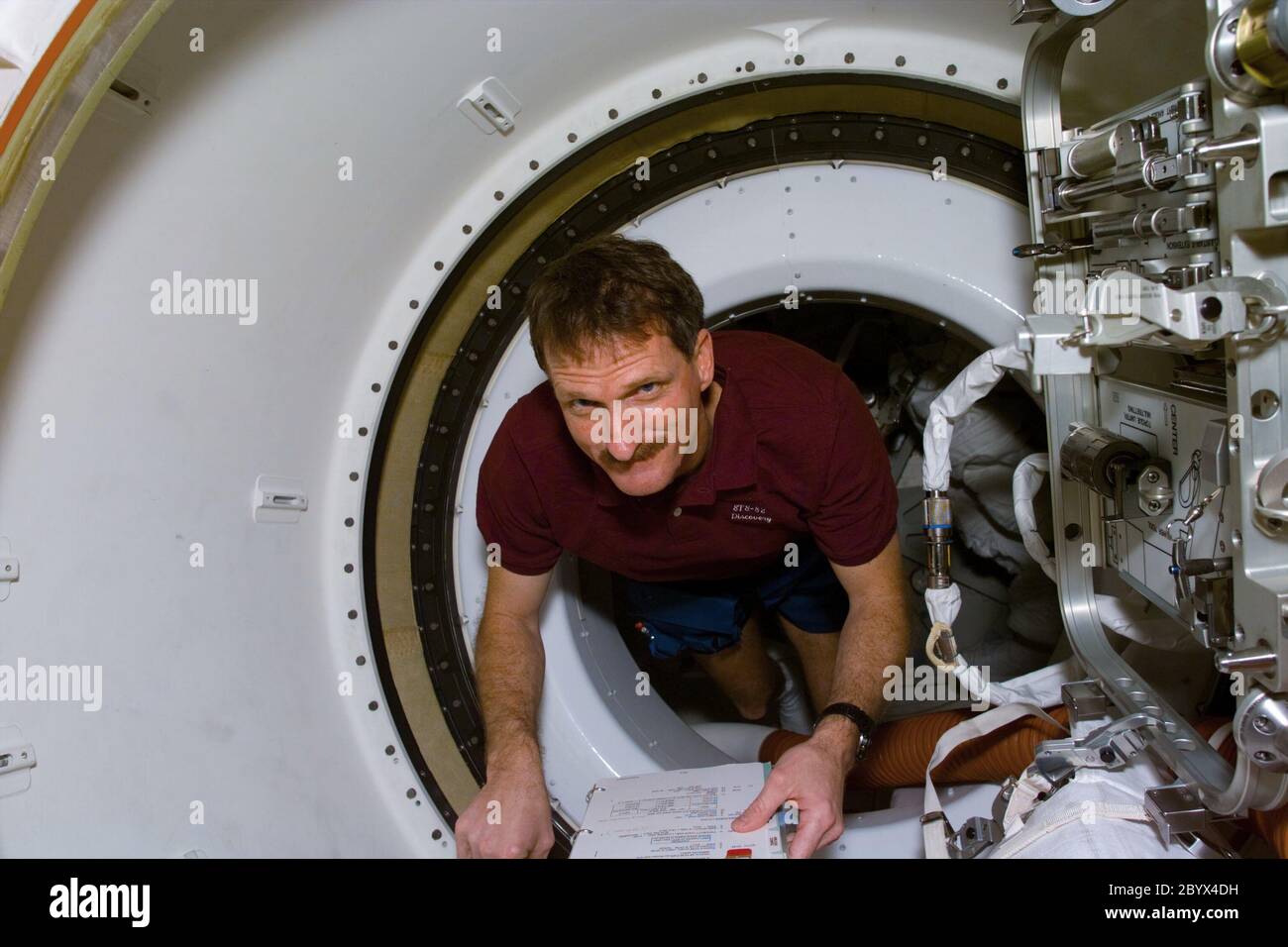 (12 Feb. 1997) --- Astronaut Joseph R. Tanner, STS-82 mission specialist, in hatchway to the Space Shuttle Discovery's airlock where he will later don an Extravehicular Mobility Unit (EMU) space suit for servicing tasks on Hubble Space Telescope (HST). Stock Photo