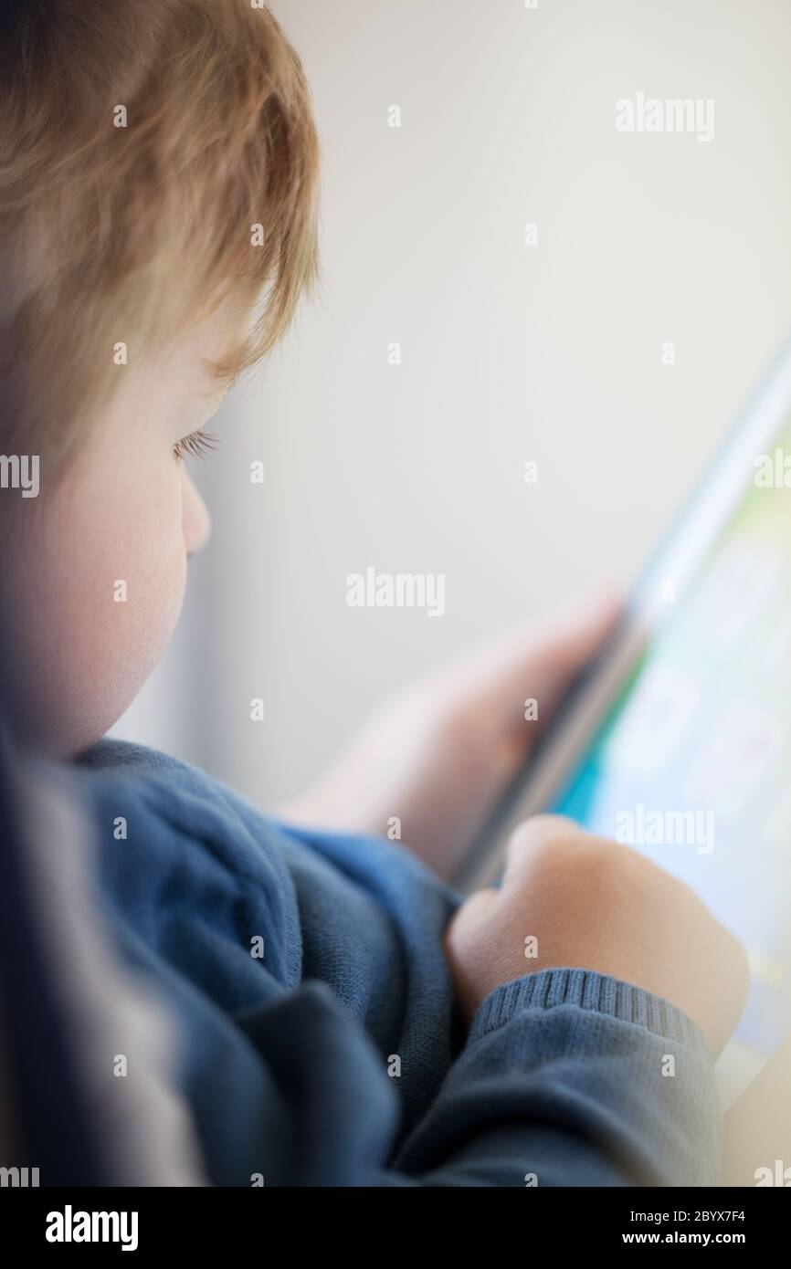 Young boy using smart tablet Stock Photo