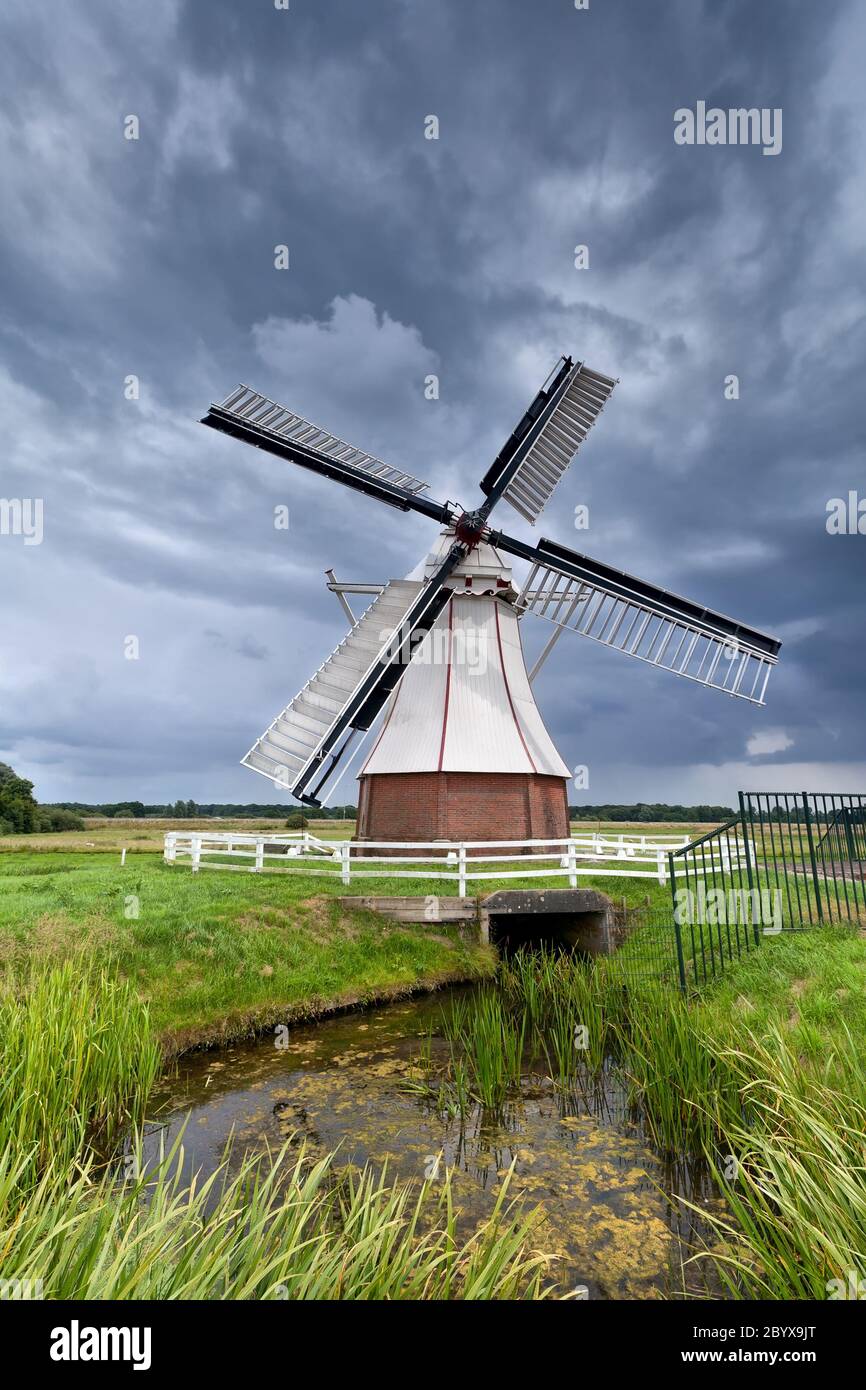 Dutch windmill over clouded sky Stock Photo