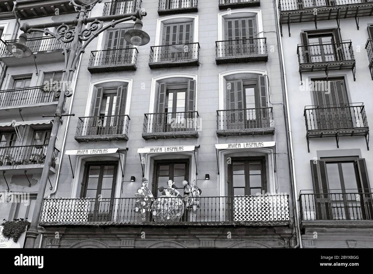 A historic multi-story residential building with terraces and wooden doors in the historic old town area of Pamplona, Spain. Stock Photo