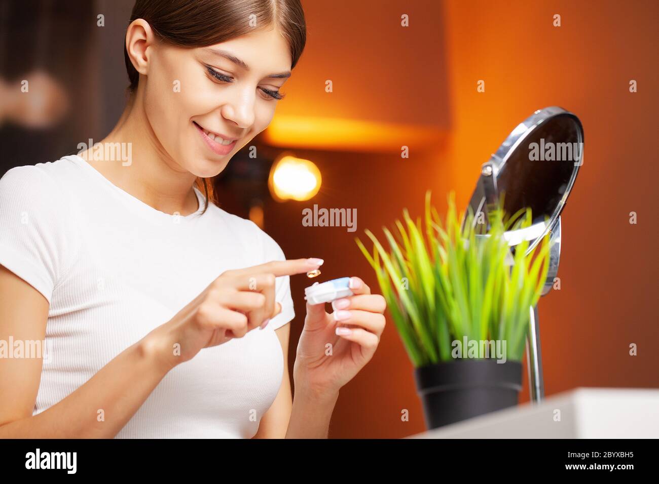 Contact lenses for vision. Young woman applies contact lenses Stock ...