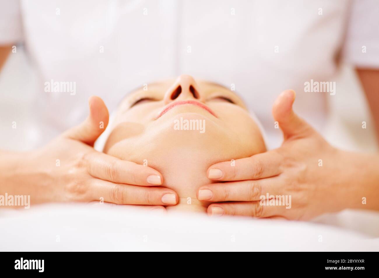 Woman under facial treatment at beauty spa Stock Photo